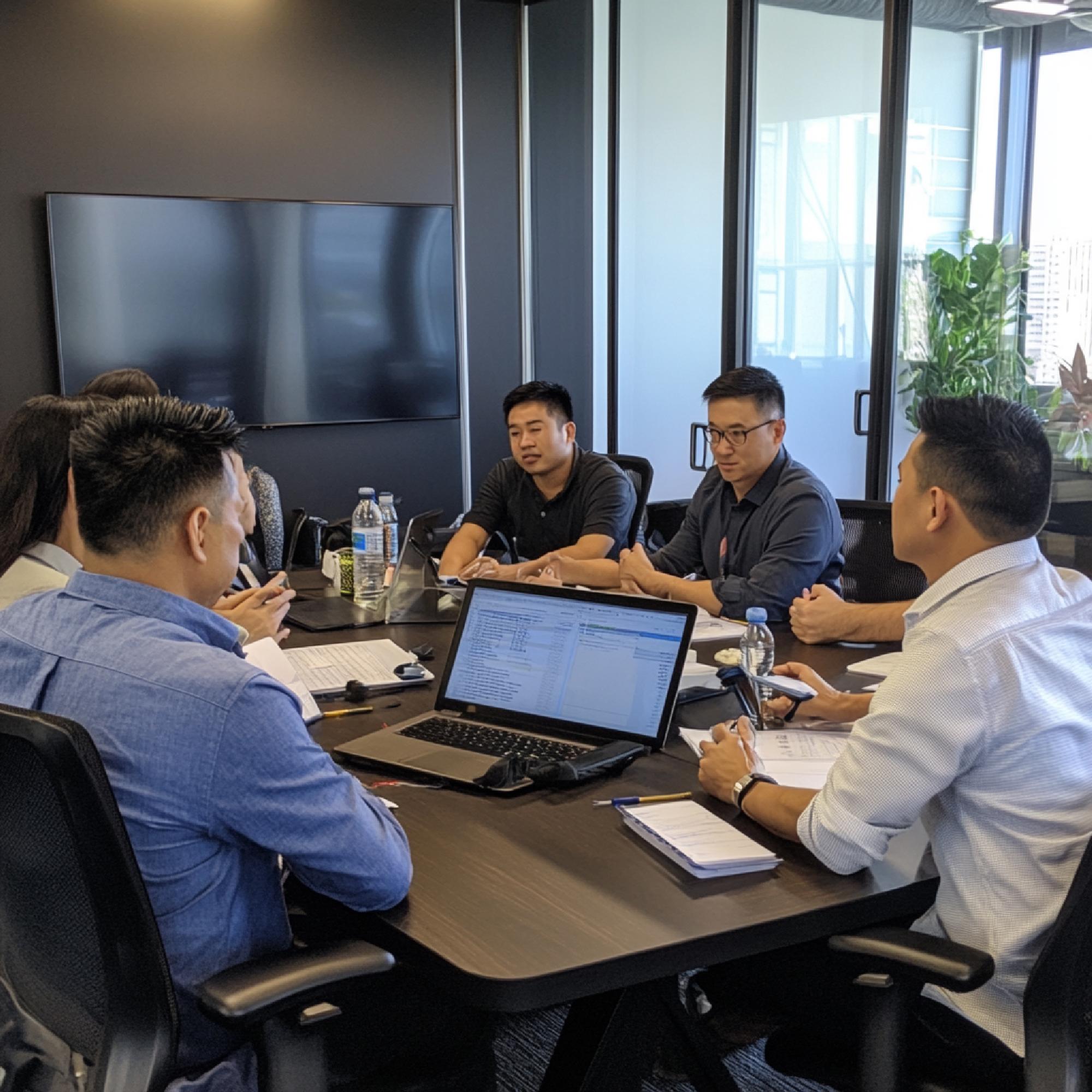 Professional digital technology team members collaborating on innovative solutions in Malaysia