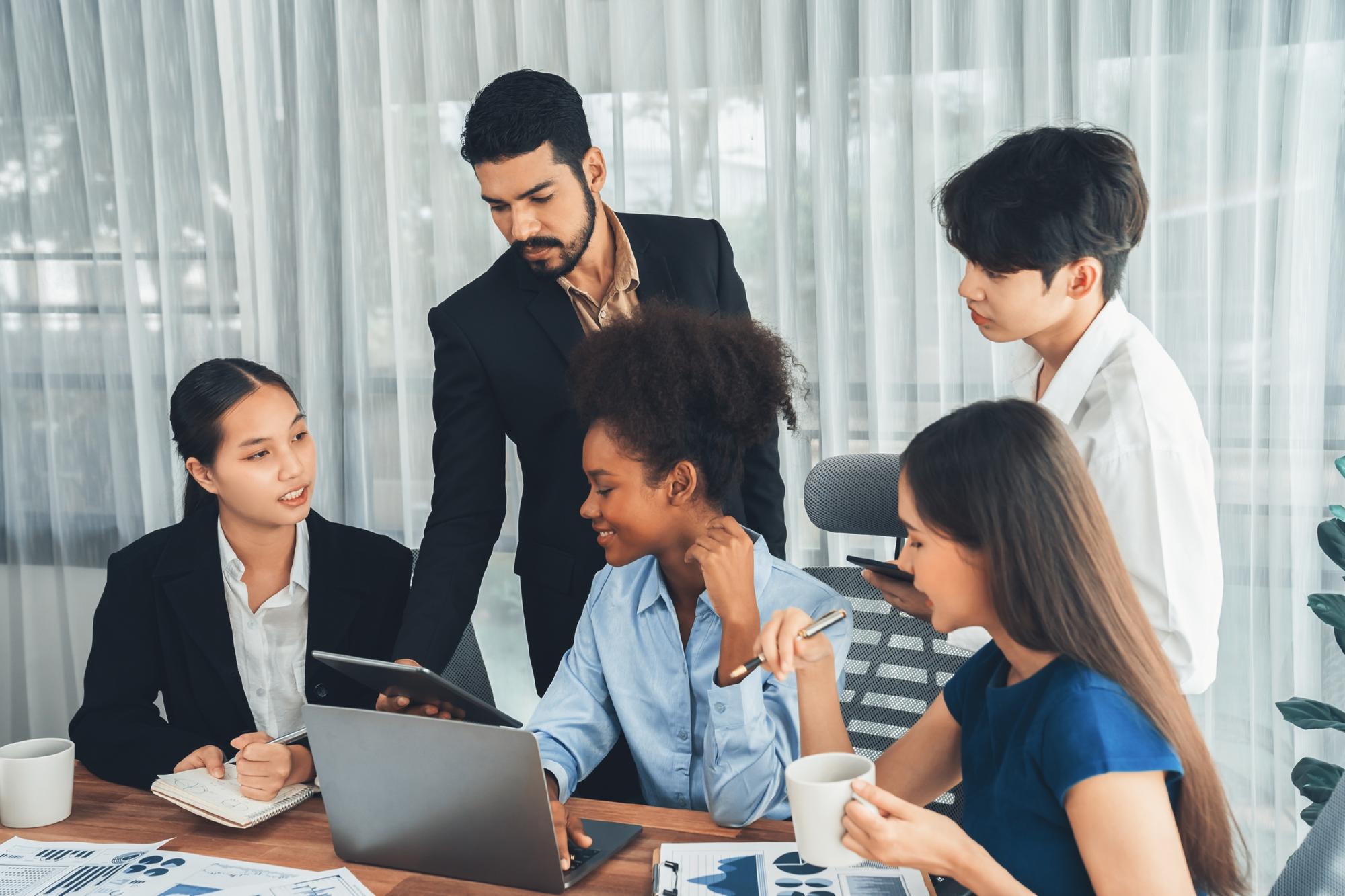 Team collaboration meeting with diverse professionals working together